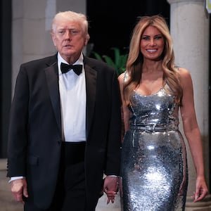 PALM BEACH, FLORIDA - DECEMBER 31: U.S. President Donald Trump and first lady Melania Trump arrive for a New Year’s Eve event at his Mar-a-Lago home on December 31, 2025 in Palm Beach, Florida. The president addressed guests and celebrated the arrival of 2026. (Photo by Joe Raedle/Getty Images)