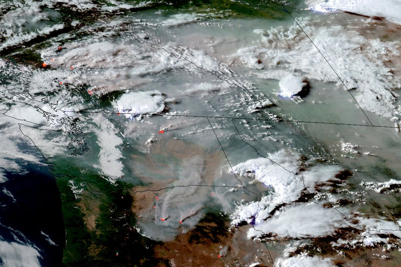 A satellite image shows smoke from wildfires in Oregon, Washington state and the Canadian province of British Columbia drifting eastward in North America, July 24, 2026.