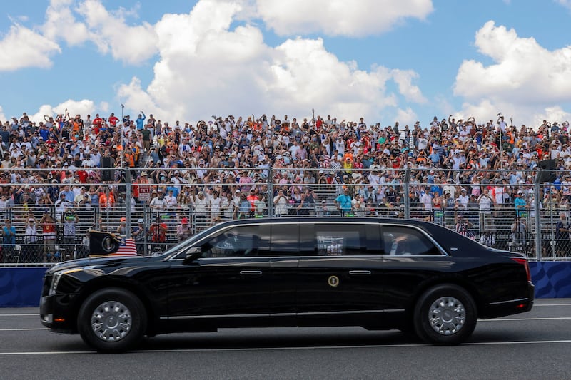 First lady Melania Trump waves as she and U.S. President Donald Trump ride in the presidential limousine, known as "The Beast", ahead of the start of the Freedom 250 Grand Prix IndyCar series race in Washington, D.C., U.S., August 23, 2026. REUTERS/Tierney Cross