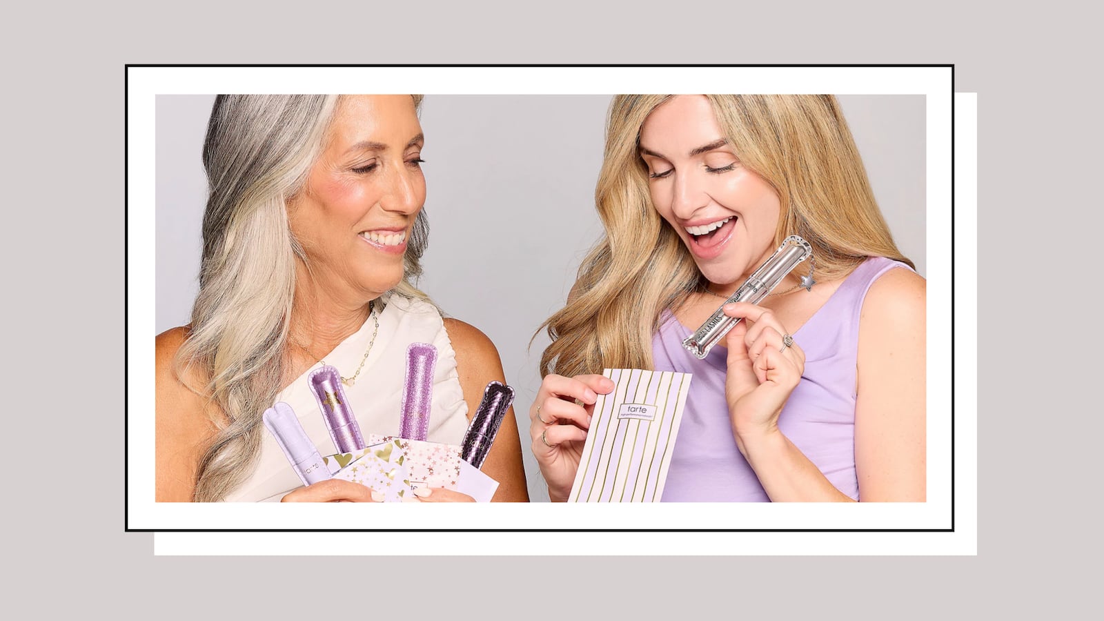 Two women holding Tarte's Lights, Camera, Lashes mascara set, available at QVC