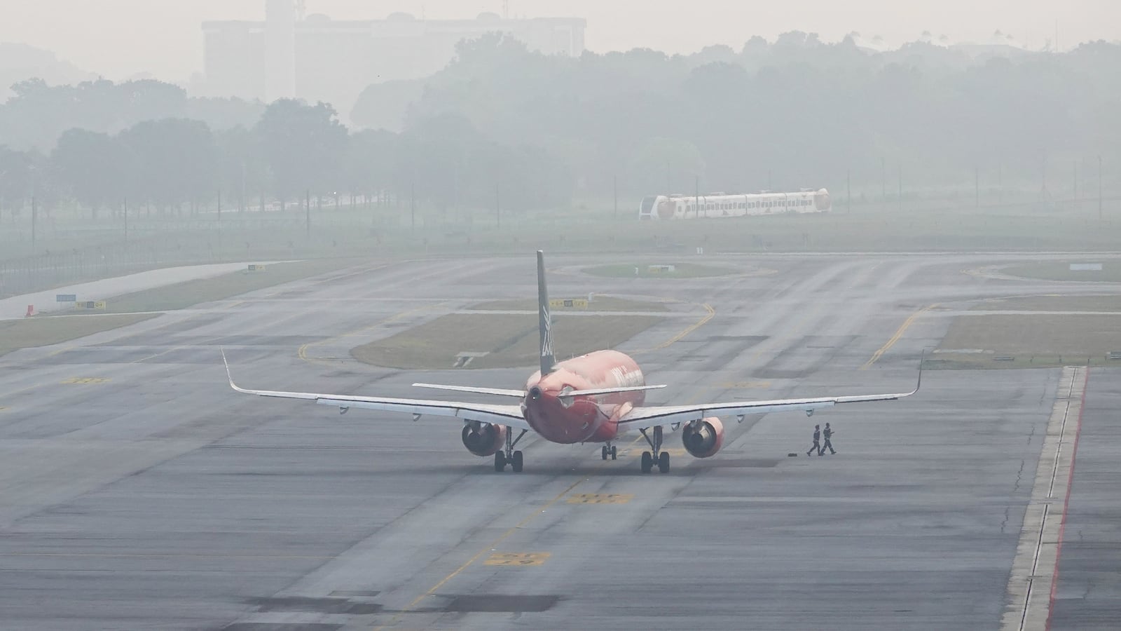 An aeroplane is prepared for take off during the haze at the Kuala Lumpur International Airport on October 8, 2023.