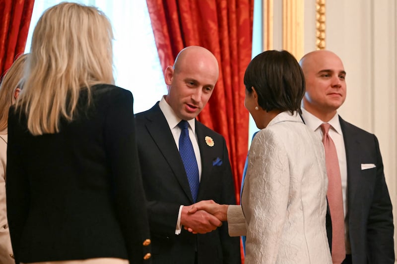 White House deputy chief of staff Stephen Miller (C) shakes hands with Japan's Prime Minister Sanae Takaichi