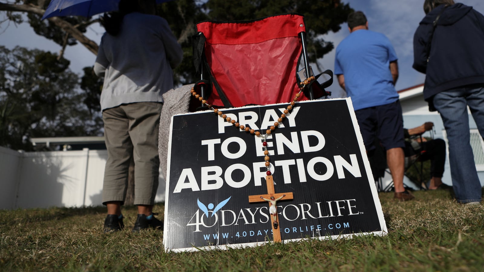 Anti-abortion activists representing their Catholic belief pray with other parishioners and protesters while they shout at patients arriving outside of a clinic that provides abortions in Clearwater, Florida, U.S. February 11, 2023.
