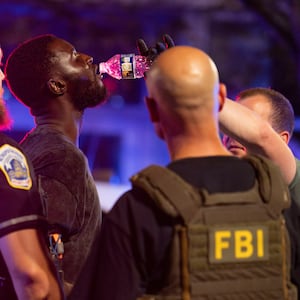 WASHINGTON, DC - AUGUST 17: Members of the Federal Bureau of Investigation (FBI), Homeland Security Investigations (HSI), the Secret Service, and Metropolitan Police Department (MPD) give an individual they detained water on 7th Street NW on August 17, 2025 in Washington, DC. U.S. President Donald Trump deployed federal officers and the National Guard to the District in order to place the DC Metropolitan Police Department under federal control and assist in crime prevention in the nation's capital. (Photo by Kayla Bartkowski/Getty Images)