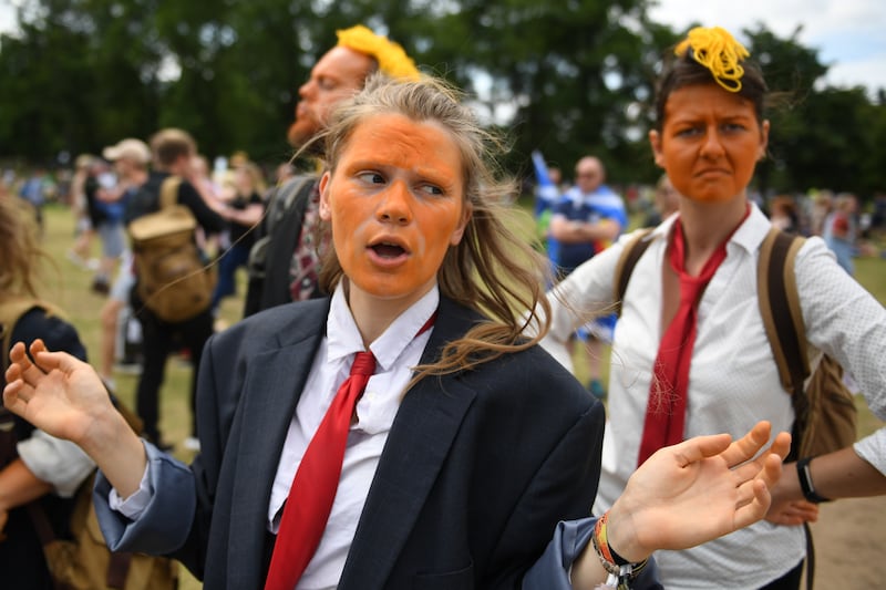 EDINBURGH, SCOTLAND - JULY 14: Protesters wear orange face makeup while the U.S. President is visiting Trump Turnberry Luxury Collection Resort in Scotland as people gather for anti-Trump rallies during his visit to the United Kingdom on July 14, 2018 in Edinburgh, Scotland. The President of the United States and First Lady, Melania Trump on their first official visit to the UK after yesterday's meetings with the Prime Minister and the Queen is in Scotland for private weekend stay at his Turnberry. (Photo by Jeff J Mitchell/Getty Images)