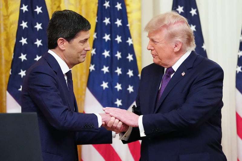 U.S. President Donald Trump shakes hands with the new Chairman of the Federal Reserve Kevin Warsh.