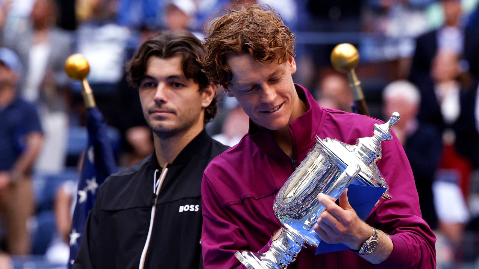 Italy's Jannik Sinner looks at the trophy after winning his men's final match against USA's Taylor Fritz