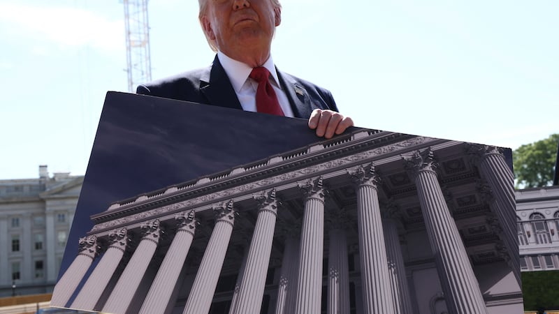 U..S. President Donald Trump shows an image of the concept at the site of ongoing construction of the planned White House ballroom in Washington, D.C., U.S., May 19, 2026. REUTERS/Kevin Lamarque
