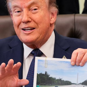 U.S. President Donald Trump shows an image as he speaks about renovations at the Lincoln Memorial Reflecting Pool during a healthcare affordability event in the Oval Office at the White House in Washington, D.C., U.S., April 23, 2026. REUTERS/Kylie Cooper