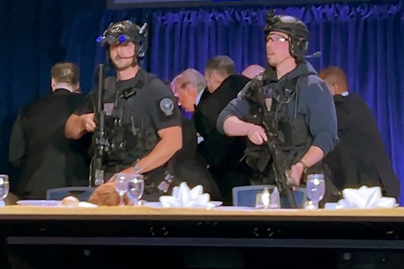 U.S. President Donald Trump is escorted out after a man opened fire with a shotgun on security personnel outside the room, during the annual White House Correspondents' Association dinner in Washington, D.C., U.S., April 25, 2026, in this still image from video. REUTERS/Bo Erickson THIS IMAGE WAS PROCESSED BY REUTERS TO ENHANCE QUALITY, AN UNPROCESSED VERSION HAS BEEN PROVIDED SEPARATELY.