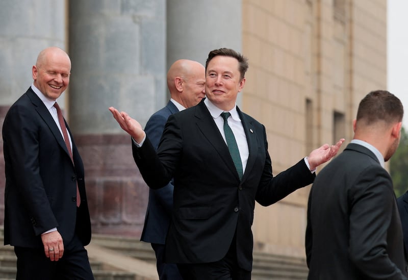 Elon Musk gestures as he leaves after attending a welcome ceremony for U.S. President Donald Trump with Chinese President Xi Jinping at the Great Hall of the People in Beijing, China, May 14, 2026.