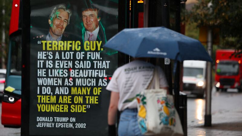 A person walks past a poster with a photograph of Donald Trump, now serving as the U.S. President, and disgraced financier and sex offender Jeffrey Epstein, protesting Trump’s upcoming state visit to the UK, in London, Britain, September 3, 2025.
