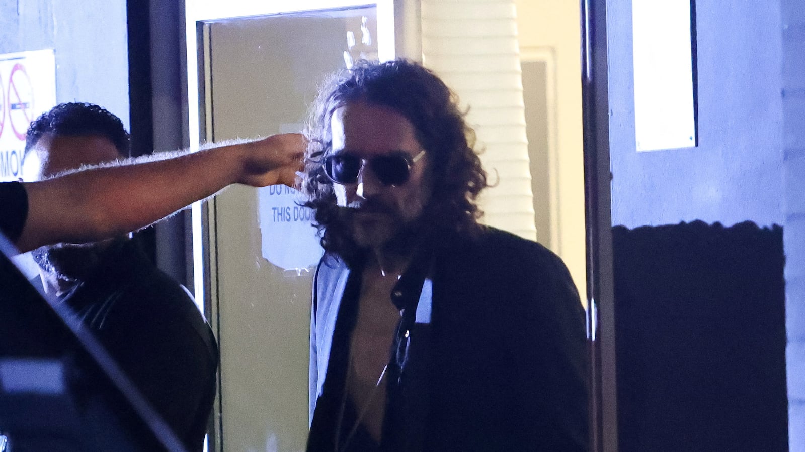 British comedian and actor Russell Brand walks outside the Wembley Park Theatre, in northwest London, Britain
