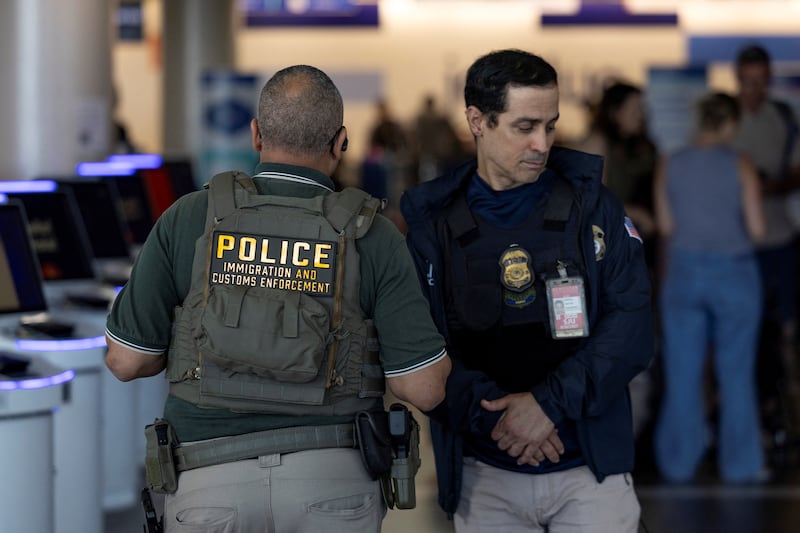 United States Immigration and Customs Enforcement (ICE) agents stand inside a terminal after hundreds of Immigration and Customs Enforcement agents were ordered to deploy to airports to help fill TSA staffing gaps at Luis Munoz Marin International Airport in Carolina, Puerto Rico, March 24, 2026.