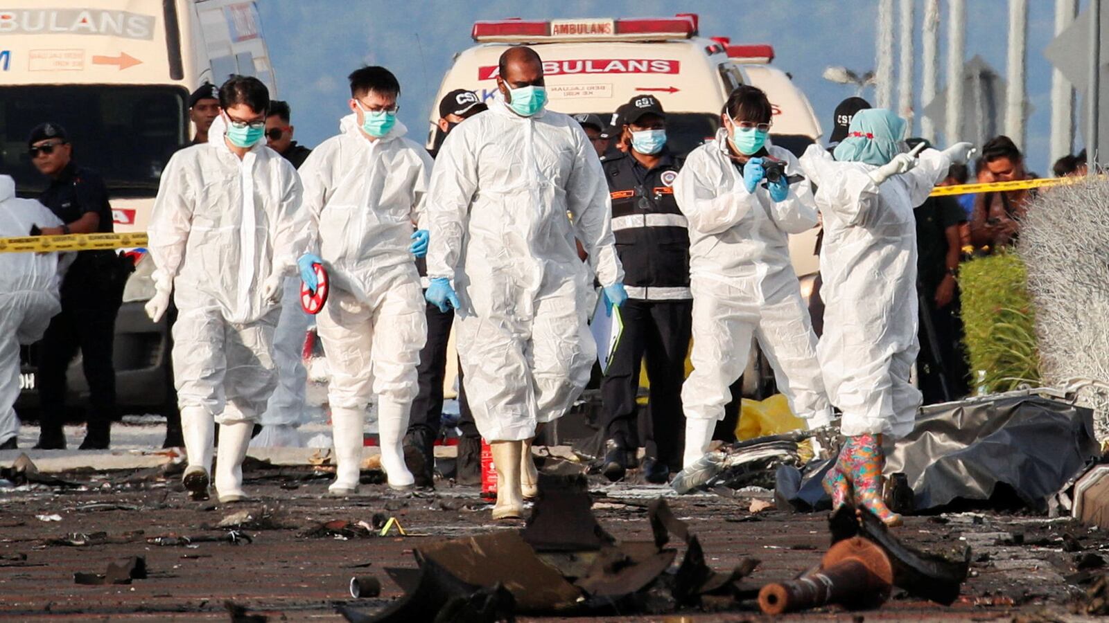 Authorities inspect the scene of a private plane crash in Shah Alam, Malaysia, Aug. 17, 2023.