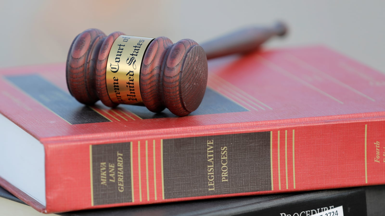 A gavel sits on top of legal books.