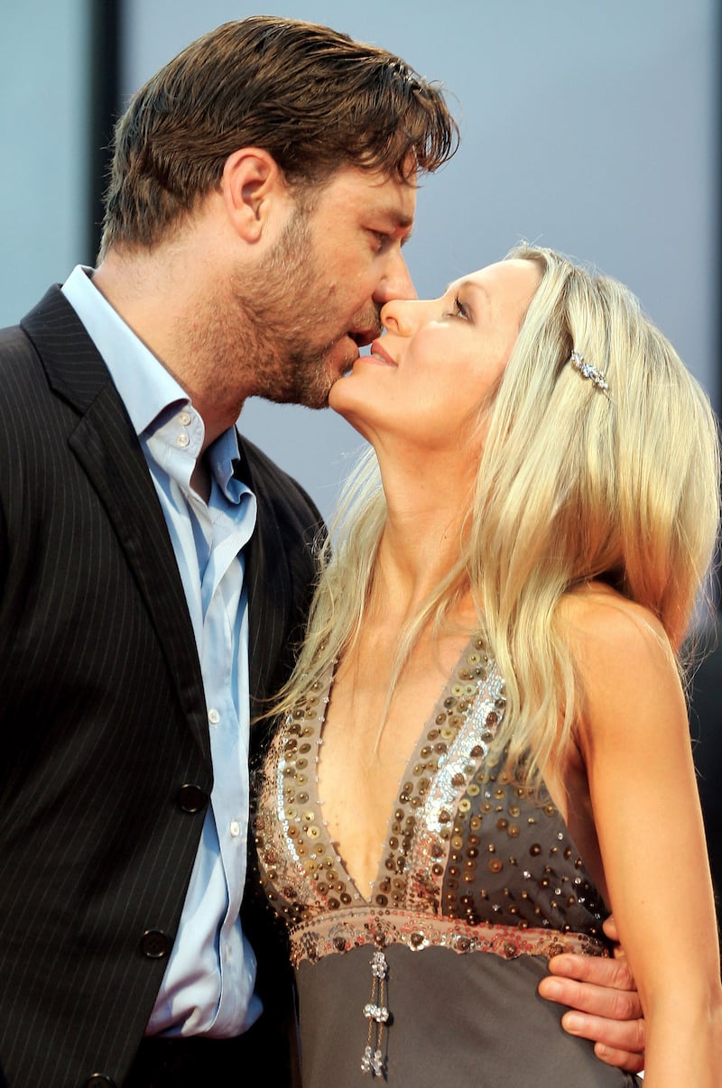 New Zealand-born actor Russell Crowe and his wife, Danielle Spencer, kiss as they arrive at the Cinema Palace in Venice on September 5, 2005.