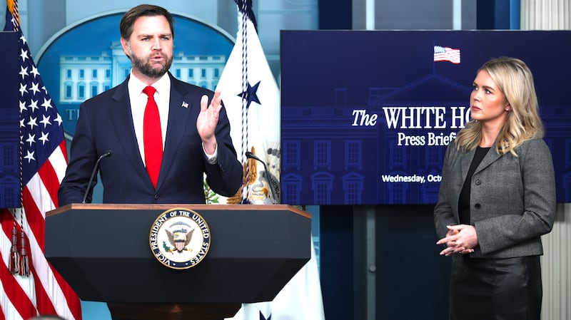 U.S. Vice President JD Vance speaks as White House Press Secretary Karoline Leavitt (R) looks on.