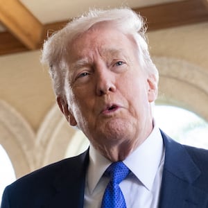 US President Donald Trump speaks to the press as he arrives to attend the wedding of Dan Scavino, White House Deputy Chief of Staff, and Erin Elmore, the Department of State Director of Art in Embassies, at Mar-a-Lago in Palm Beach, Florida, February 1, 2026. (Photo by SAUL LOEB / AFP via Getty Images)