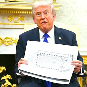 President Donald Trump shows the floor plan of his planned ballroom in the Oval Office of the White House in Washington, DC, on October 22, 2025.