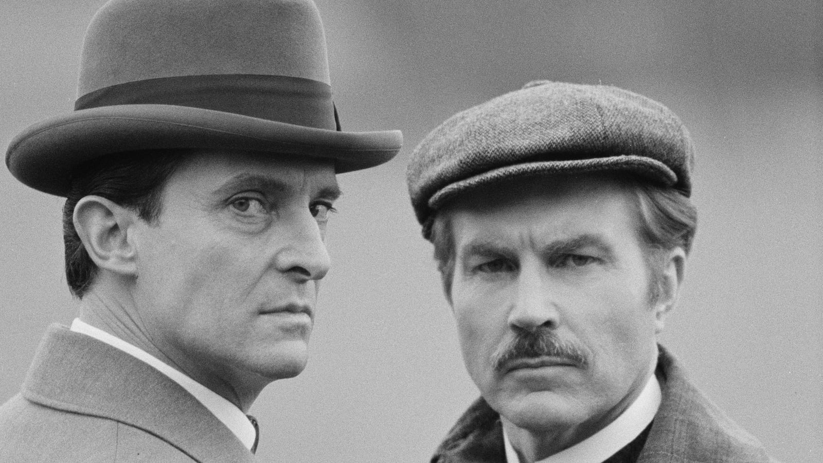 English actors Jeremy Brett (1933 - 1995) and David Burke (right) star in the television series 'The Adventures of Sherlock Holmes', UK, 7th March 1984.