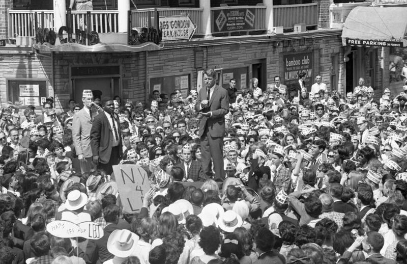 Attorney General Robert Kennedy is surrounded by admiring crowds as he delivers an impromptu speech on an Atlantic City street.