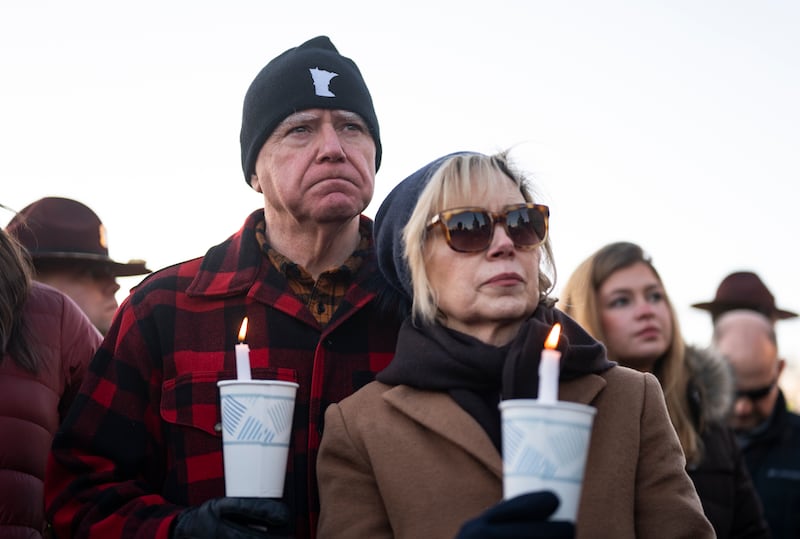 ST. PAUL, MINNESOTA - JANUARY 09: Minnesota Gov. Tim Walz (L) and his wife Gwen Walz (R) look on during a vigil for Renee Good on the steps of the state capitol building on January 09, 2026 in St. Paul, Minnesota. Earlier this week a federal agent fatally shot Good in her car during an incident in south Minneapolis. (Photo by Stephen Maturen/Getty Images)