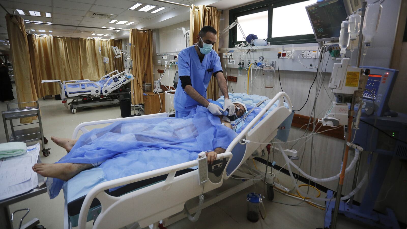 Sick and injured Palestinians receive treatment with limited facilities at the Al-Aqsa Martyrs Hospital in Deir al-Balah, Gaza.