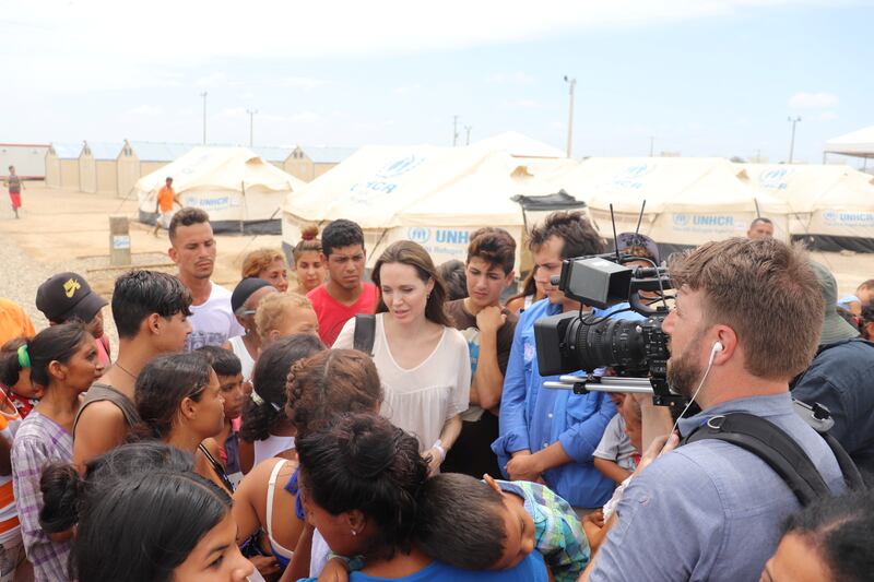 talks to people inside a camp run by the UN Refugee Agency, UNHCR, in Maicao, Colombia June 8, 2019. Courtesy of Colombian Foreign Ministry/Handout via REUTERS ATTENTION EDITORS - THIS IMAGE WAS PROVIDED BY A THIRD PARTY