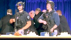 U.S. President Donald Trump is escorted out after a man opened fire with a shotgun on security personnel outside the room, during the annual White House Correspondents' Association dinner in Washington, D.C., U.S., April 25, 2026, in this still image from video.