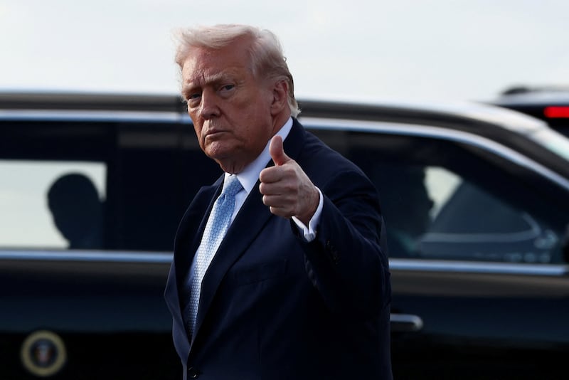 U.S. President Donald Trump gestures with a thumbs up as he steps from Air Force One upon his arrival in West Palm Beach, Florida