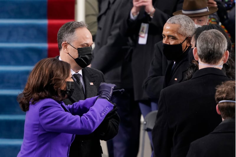 Kamala Harris and her husband Doug Emhoff, greeted by former President Barack Obama and Michelle Obama, in 2021 while masks were still required as a result of the COVID pandemic.