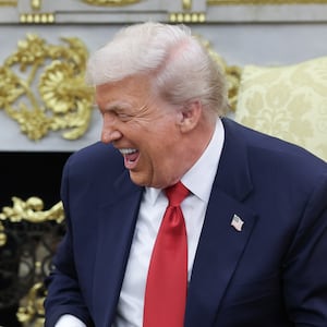 U.S. President Donald Trump (R) jokes with Crown Prince and Prime Minister Mohammed bin Salman of Saudi Arabia during a bilateral meeting in the Oval Office of the White House on November 18, 2025 in Washington, DC.