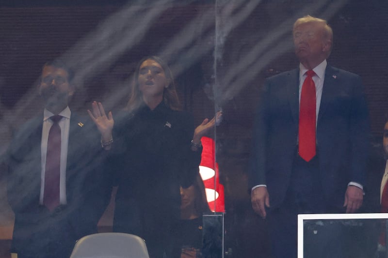 U.S. President Donald Trump, his son Donald Trump Jr. with his girlfriend Bettina Anderson, attend a memorial service for slain conservative commentator Charlie Kirk at State Farm Stadium, in Glendale, Arizona, U.S., September 21, 2025.  REUTERS/Carlos Barria