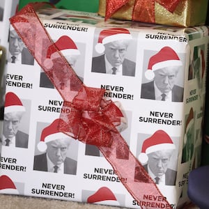 WATERLOO, IOWA - DECEMBER 19: Gifts wrapped in Christmas wrapping paper featuring the likeness of Republican presidential candidate former U.S. President Donald Trump sit on the stage during a rally hosted by the former president on December 19, 2023 in Waterloo, Iowa. Iowa Republicans will be the first to select their party's nomination for the 2024 presidential race, when they go to caucus on January 15, 2024. (Photo by Scott Olson/Getty Images)