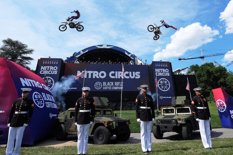 Motorsports athletes and stunt performers do a motorcycle jump ahead of the UFC Freedom 250 fights on the South Lawn.