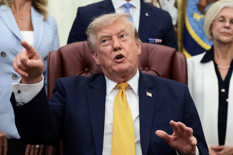 U.S. President Donald Trump points his finger as he answers questions from the media after signing an executive order establishing the President's Military Spouse Commission to be chaired by Jennifer Rauchet, wife of Secretary of Defense Pete Hegseth, in the Oval Office at the White House in Washington, D.C., U.S., August 3, 2026. REUTERS/Evelyn Hockstein