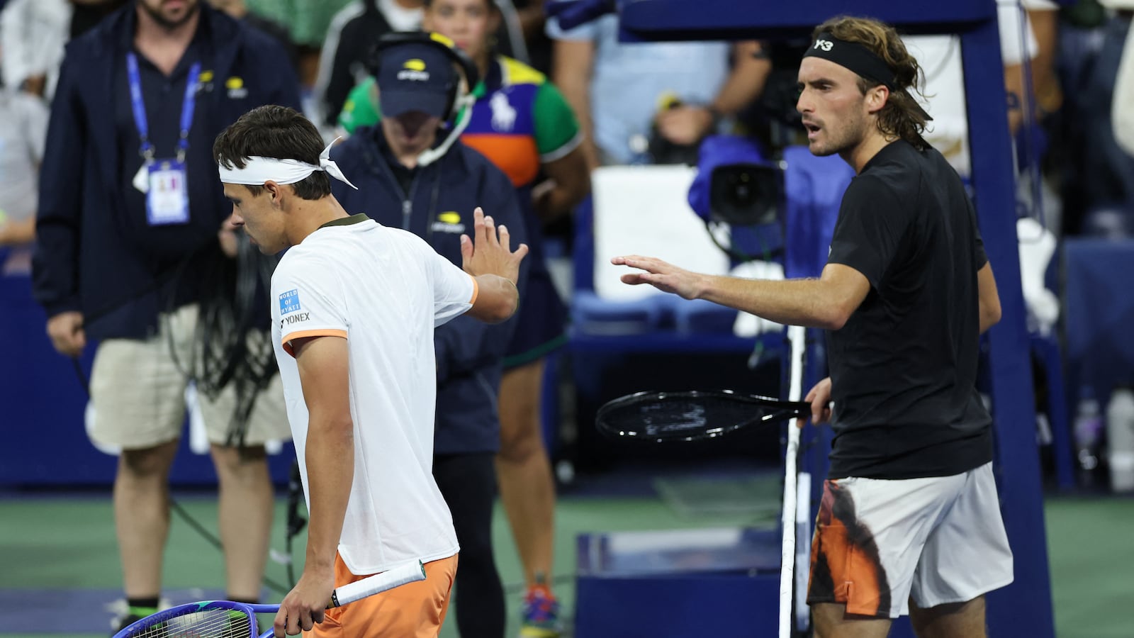 Germany's Daniel Altmaier (L) and Greece's Stefanos Tsitsipas argue after shaking hands at the net after Altmaier won their men's singles second round tennis match on day five of the US Open tennis tournament at the USTA Billie Jean King National Tennis Center in New York City, on August 28, 2025. (Photo by CHARLY TRIBALLEAU / AFP) (Photo by CHARLY TRIBALLEAU/AFP via Getty Images)