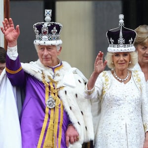 Britain's King Charles and Queen Camilla gesture as they stand on the Buckingham Palace balcony following their coronation ceremony in London, Britain May 6, 2023. REUTERS/Hannah McKay