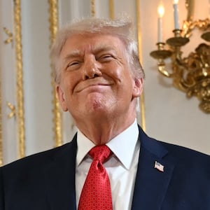 US President Donald Trump reacts as he arrives at a dedication ceremony for Southern Boulevard, in the ballroom at Mar-a-Lago in Palm Beach, Florida, on January 16, 2026. Palm Beach Southern Boulevard, between Kirk Road and South Ocean Boulevard, is being renamed as "President Donald J. Trump Boulevard." (Photo by ANDREW CABALLERO-REYNOLDS / AFP)