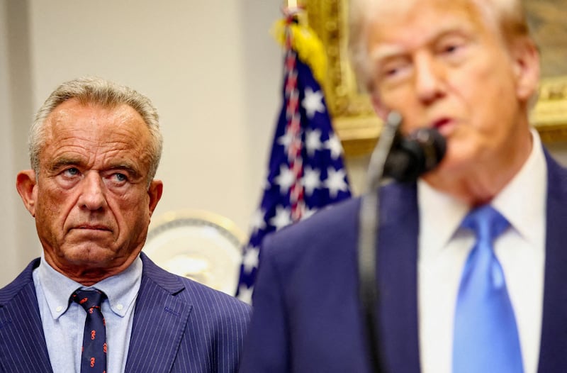 FILE PHOTO: U.S. Secretary of Health and Human Services Robert F. Kennedy Jr. looks at U.S. President Donald Trump while he makes an announcement linking autism to childhood vaccines and to the use of popular pain medication Tylenol for pregnant women and children, claims which are not backed by decades of science, at the White House, in Washington, D.C., U.S., September 22, 2025. REUTERS/Kevin Lamarque/File Photo