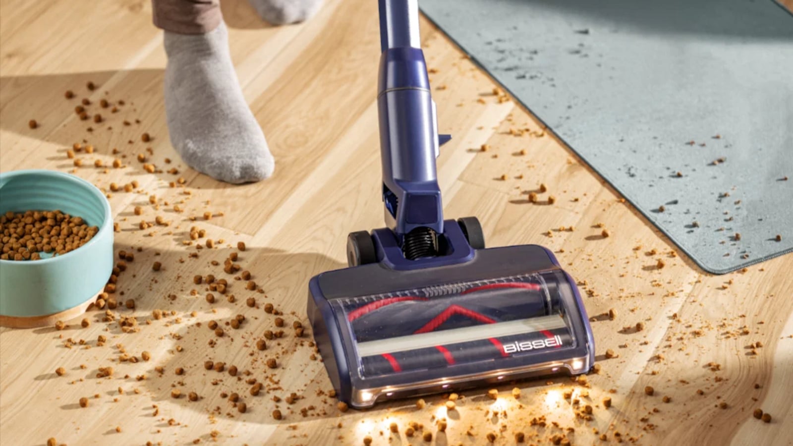 BISSELL PowerClean DualBrush cleaning up pet food on a floor