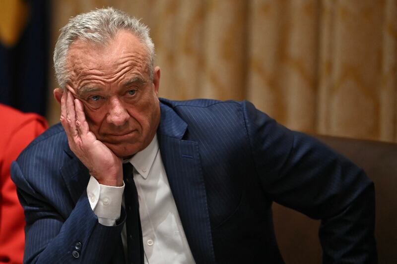 US Secretary of Health and Human Services Robert F. Kennedy Jr., look on as  President Donald Trump speaks during a Cabinet Meeting in the Cabinet Room of the White House in Washington, DC on December 2, 2025.
