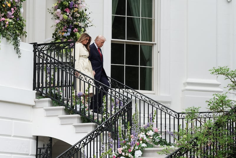Trump held onto wife Melania as he descended the steps at the White House.