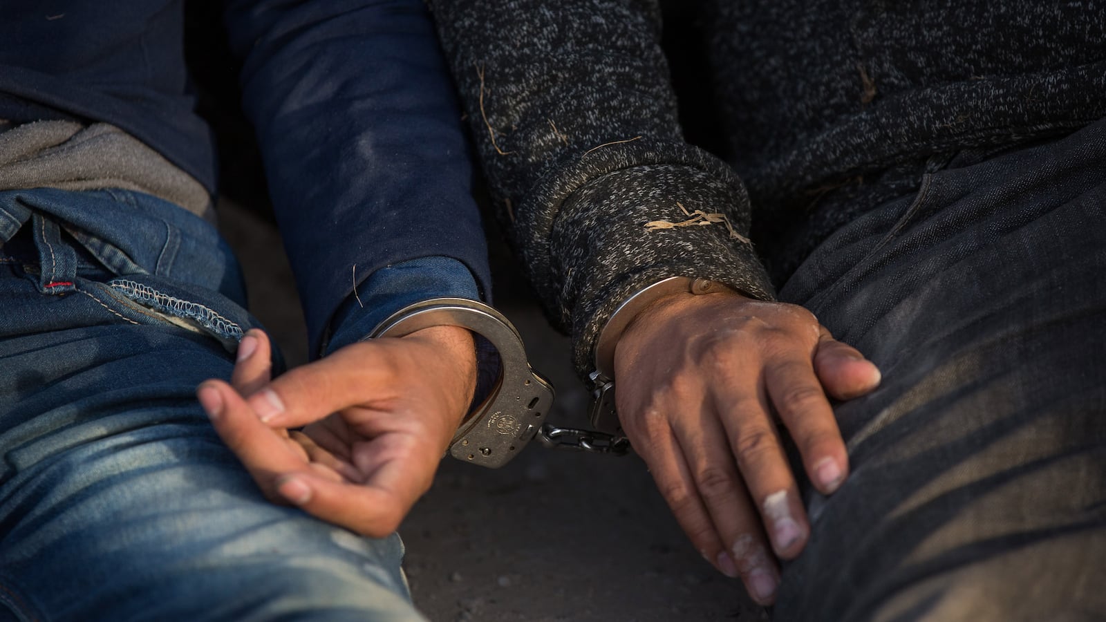 image of two men handcuffed to each other myth of criminal immigrant migrant caravan undocumented mexico central america