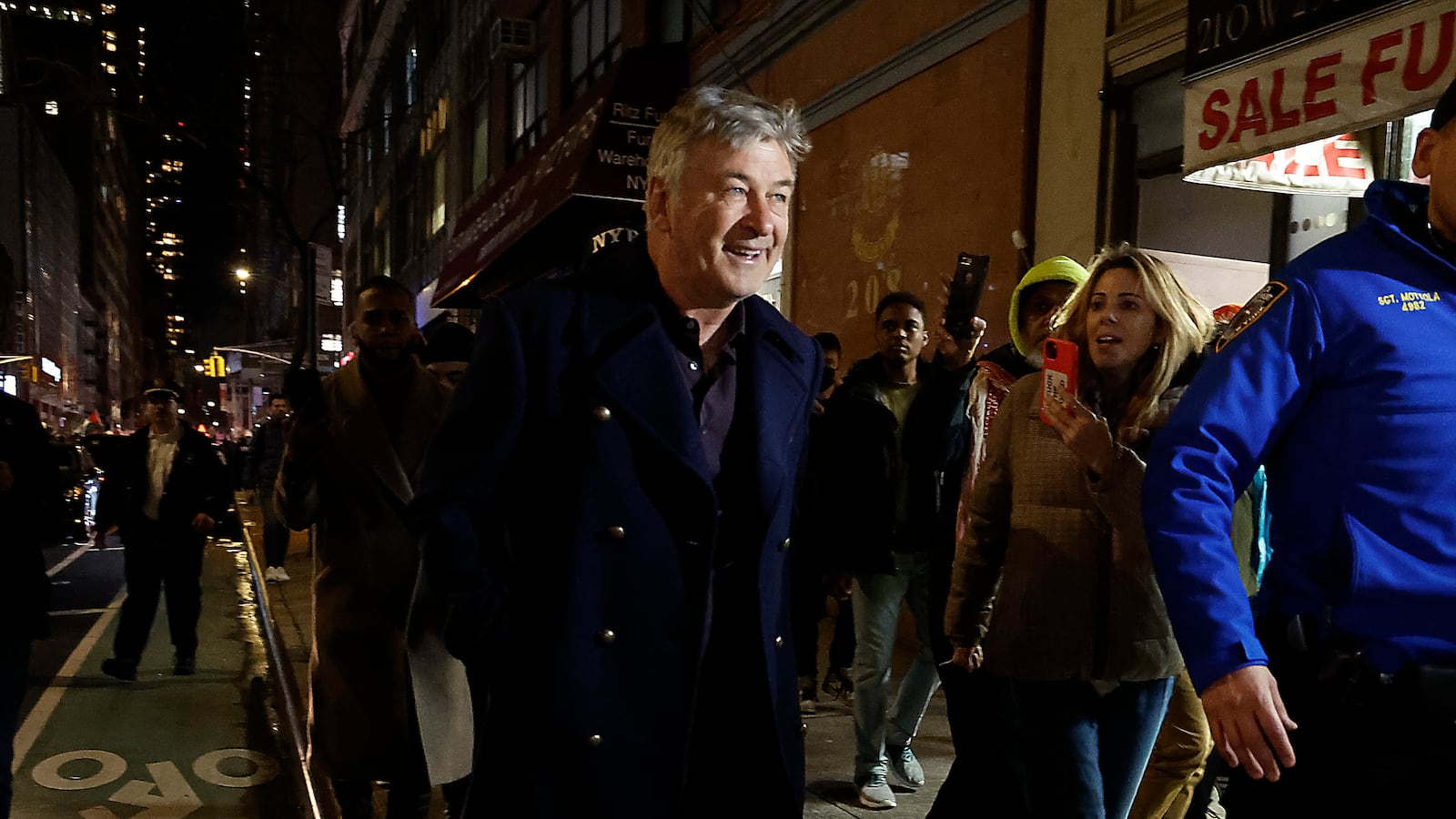 Alec Baldwin is escorted away from a pro-Palestine protest by NYPD officers after clashing with protesters in Midtown Manhattan on December 18, 2023 in New York City.