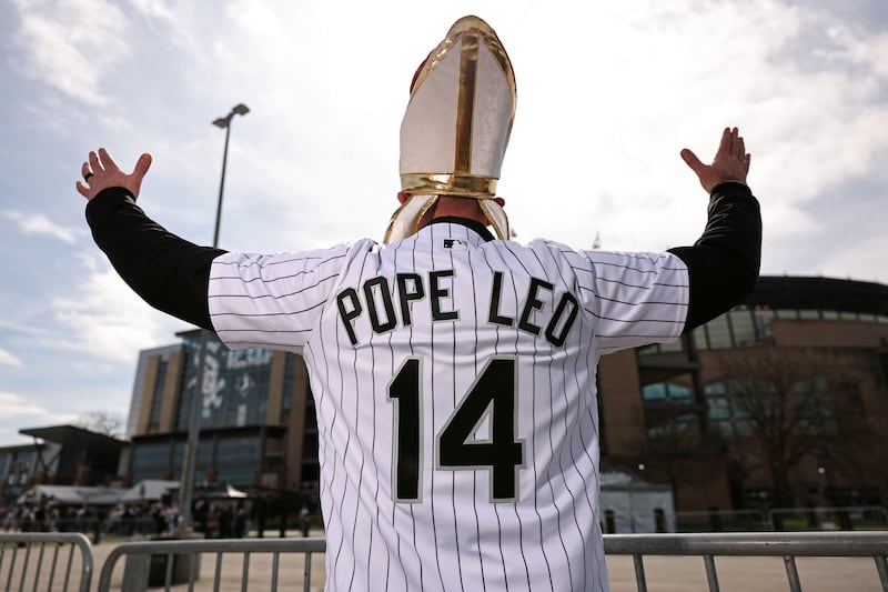 A fan with a Pope Leo jersey poses for a photo outside Rate Field prior to the game between the Toronto Blue Jays and the Chicago White Sox on Friday, April 3, 2026 in Chicago, Illinois.