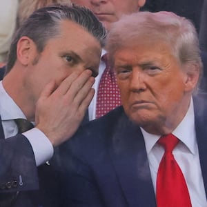 U.S. Secretary of Defense Pete Hegseth talks to U.S. President Donald Trump during the U.S. Army's 250th Birthday parade, on the same day of U.S. President Donald Trump 79th birthday, in Washington, D.C., U.S., June 14, 2025. REUTERS/Carlos Barria     TPX IMAGES OF THE DAY