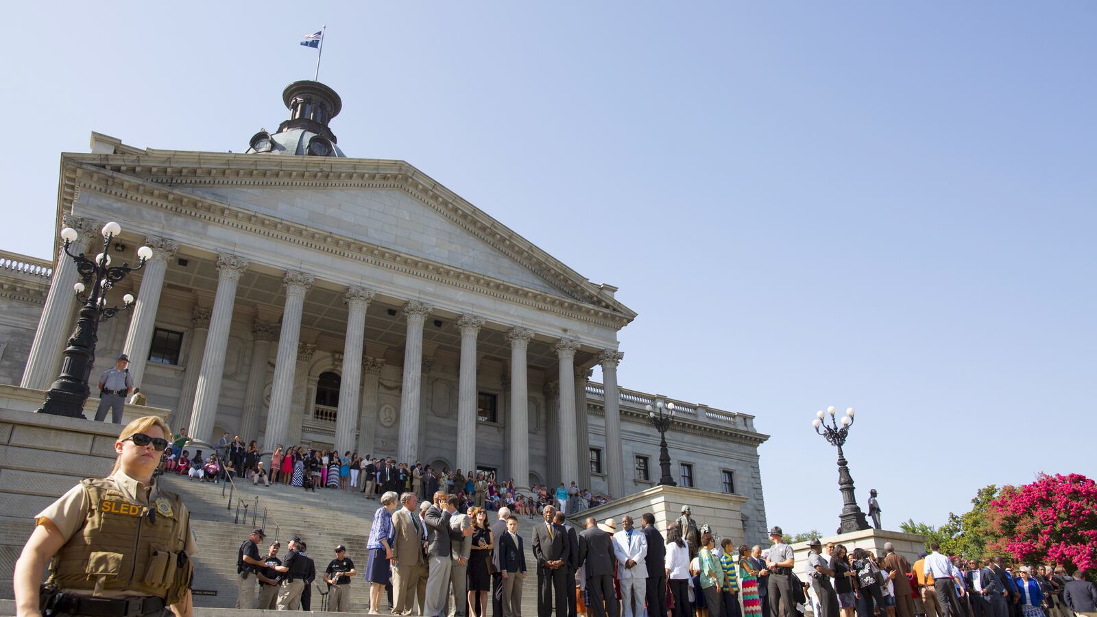 People gather on the steps of the South Carolina statehouse before a ceremony to remove the Confederate battle flag from the South Carolina statehouse