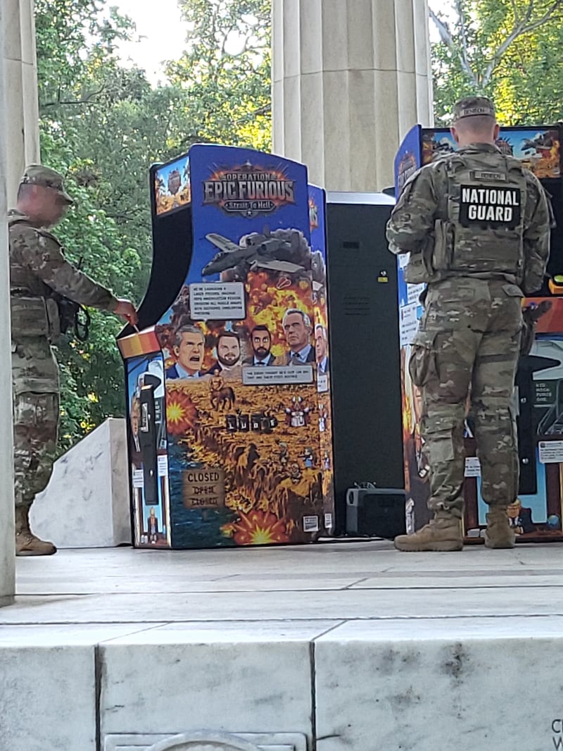 National Guardsmen play with anti-Trump gaming machines.